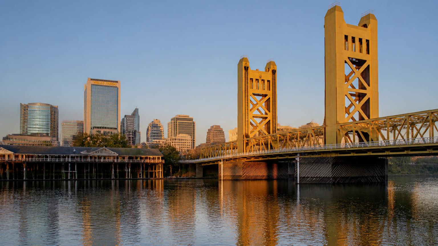 Tower Bridge & downtown Sacramento skyline — 38.5810, -121.5060 Tower Bridge over the Sacramento River with the downtown Sacramento skyline at golden hour, central reference point for the certified security guard vendor coverage region